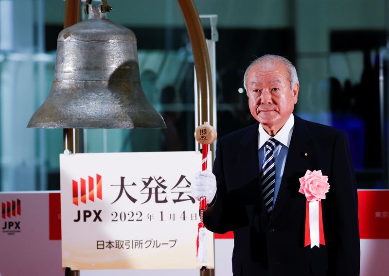Japan’s Finance Minister Shunichi Suzuki prepares to ring a bell