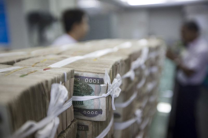 FILE PHOTO: Stacks of Myanmar kyat are seen on the