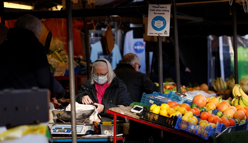 FILE PHOTO: A woman wearing a face mask shops in
