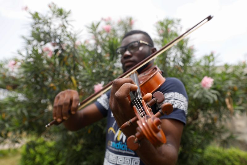 Nigerian Violinist, Peter Oluwadare, 23, who performs at weekly concerts