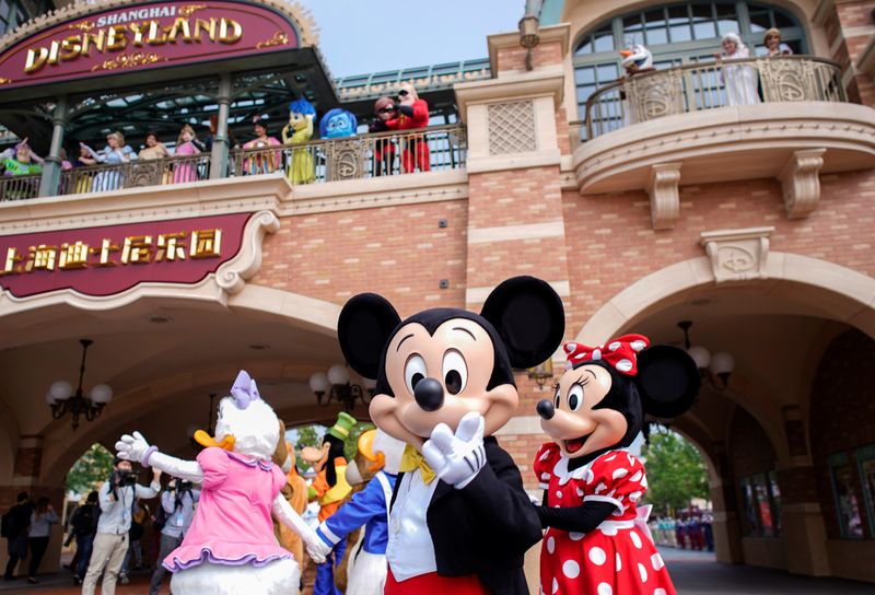 Disney characters Mickey Mouse and Minnie Mouse, among others, greet