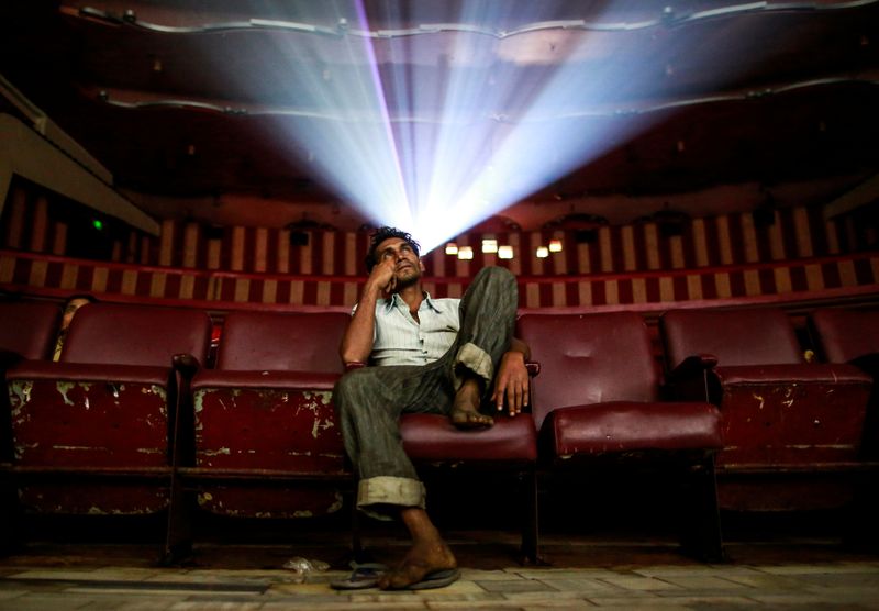 FILE PHOTO: Cinema goer watches Bollywood movie “Dilwale Dulhania Le