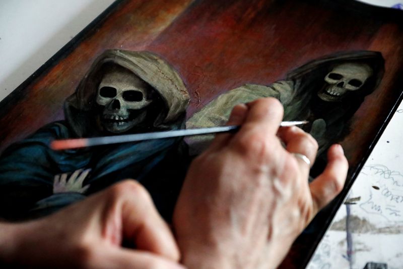 Hungarian artist Szurcsik paints in his studio in Budapest