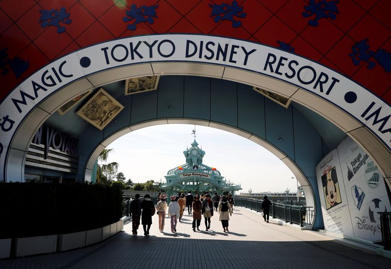FILE PHOTO: Visitors are seen outside Tokyo Disneyland in Urayasu
