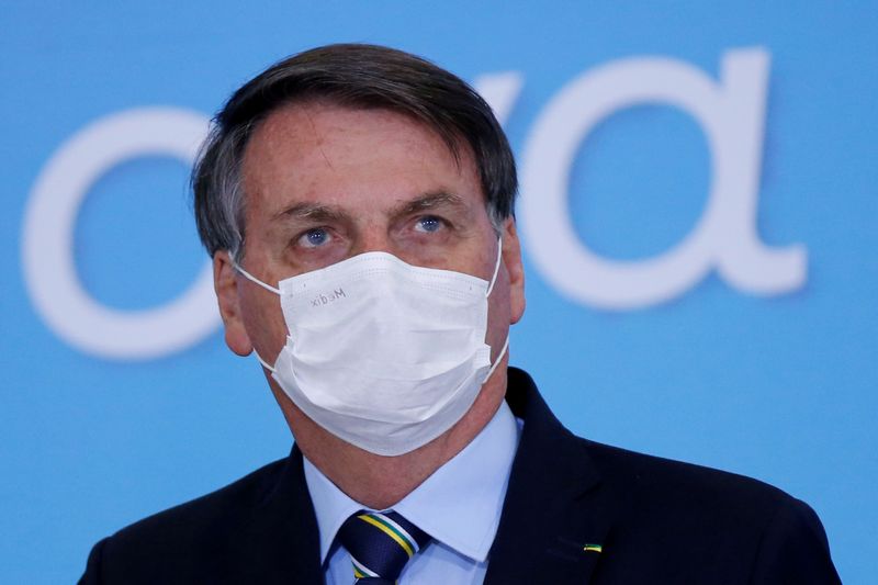 FILE PHOTO: Brazil’s President Jair Bolsonaro wearing a protective mask
