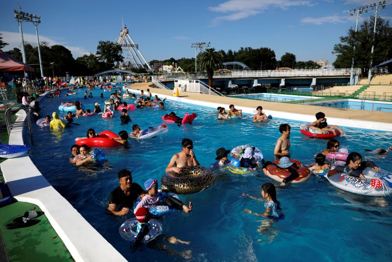 Visitors enjoy doughnut-shaped pool, amid the coronavirus disease(COVID-19) outbreak, at