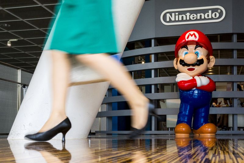FILE PHOTO: Woman walks past figure of “Mario” video game