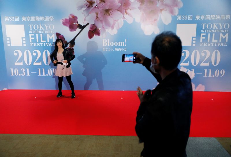 Visitors take photo on the red carpet at an entrance