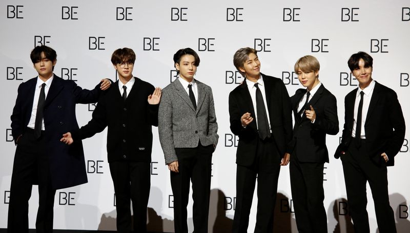 Members of K-pop boy band BTS pose for photographs during