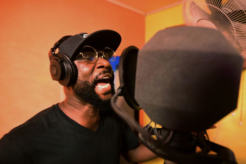 Sierra Leonean musician Emmerson Bockarie sings into a microphone while