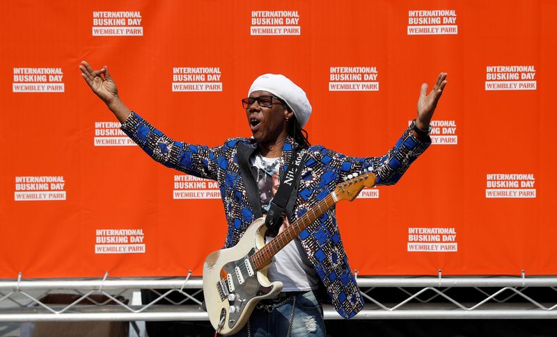 FILE PHOTO: Musician Nile Rodgers poses for photographs as he