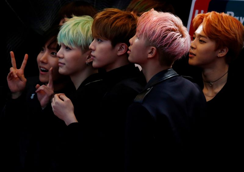 FILE PHOTO: Members of South Korean K-Pop band BTS react
