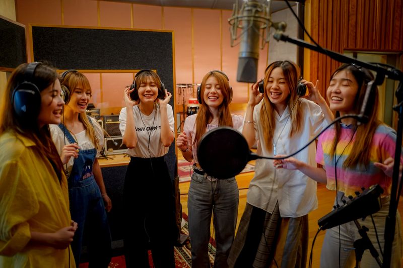 Members of Thai female band Lyra sing at a recording