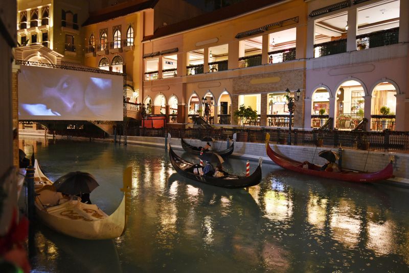 People on gondolas watch a movie while observing social distancing