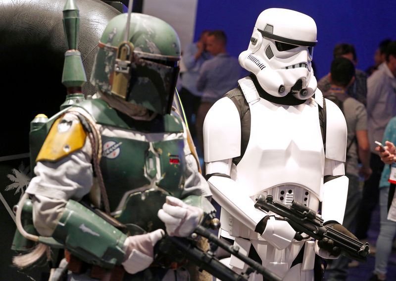 People dressed as “Star Wars” characters Boba Fett (L) and
