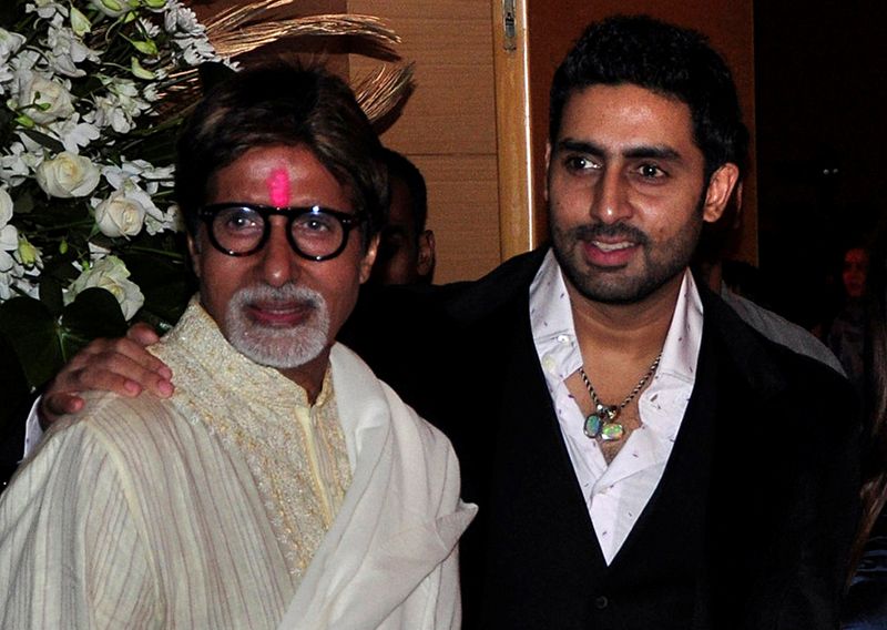 FILE PHOTO: Bollywood actors Amitabh and Abhishek Bachchan pose in