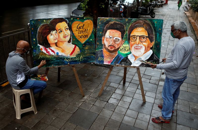 Artists create paintings depicting Bollywood actor Amitabh Bachchan, his son