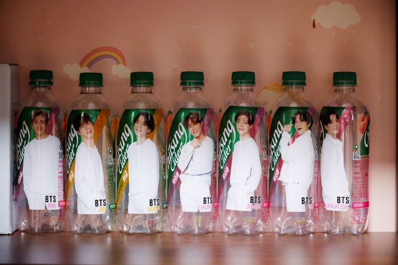 Empty soda bottles depicting members of BTS are placed on