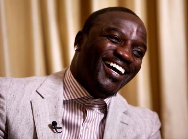 FILE PHOTO: Singer Akon laughs during an interview in New