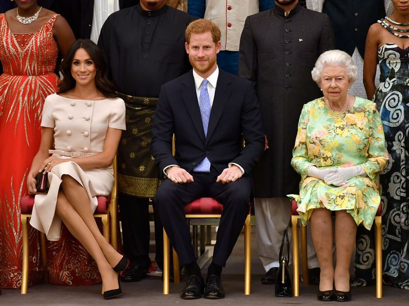 FILE PHOTO: Britain’s Queen Elizabeth, Prince Harry and Meghan, the