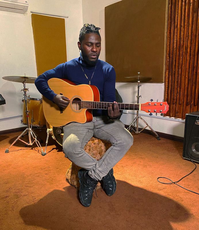 Kenyan musician Nviiri Sande plays his guitar in his studio,