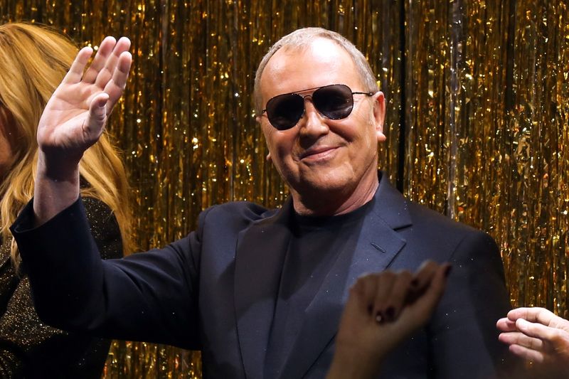 FILE PHOTO: Designer Michael Kors waves after presenting his collection
