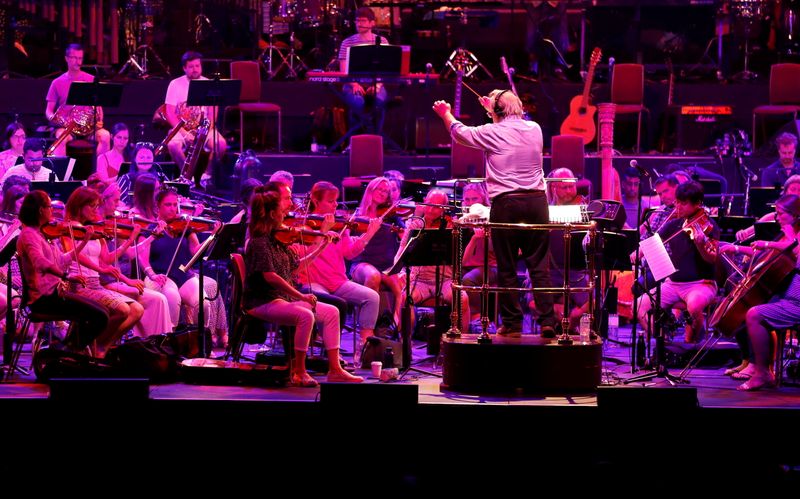 Nicholas Dodd conducts the Albert’s Orchestra during a dress rehearsal
