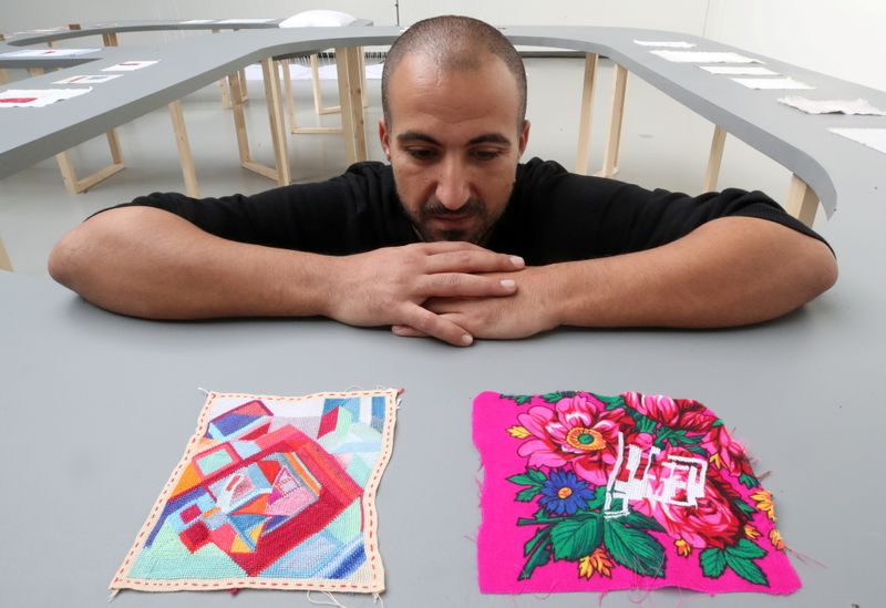 Palestinian artist Majd Abdel Hamid poses for Reuters during his