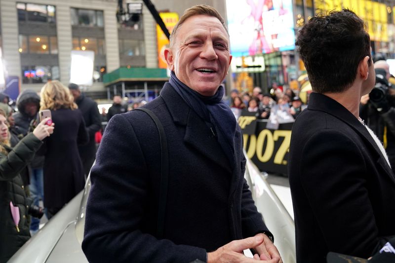 FILE PHOTO: Actor Daniel Craig reacts next to actor Rami