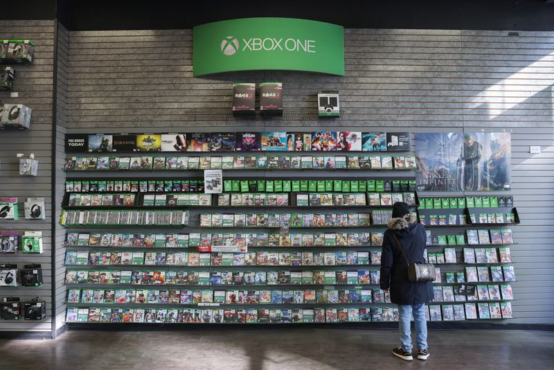 A person browses games at an XBox One Display in