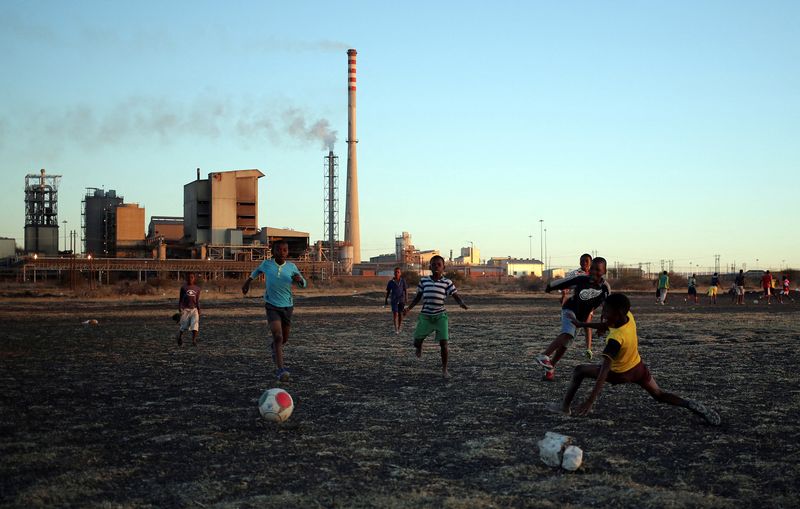 FILE PHOTO: Boys play soccer in Marikana’s Nkaneng township in