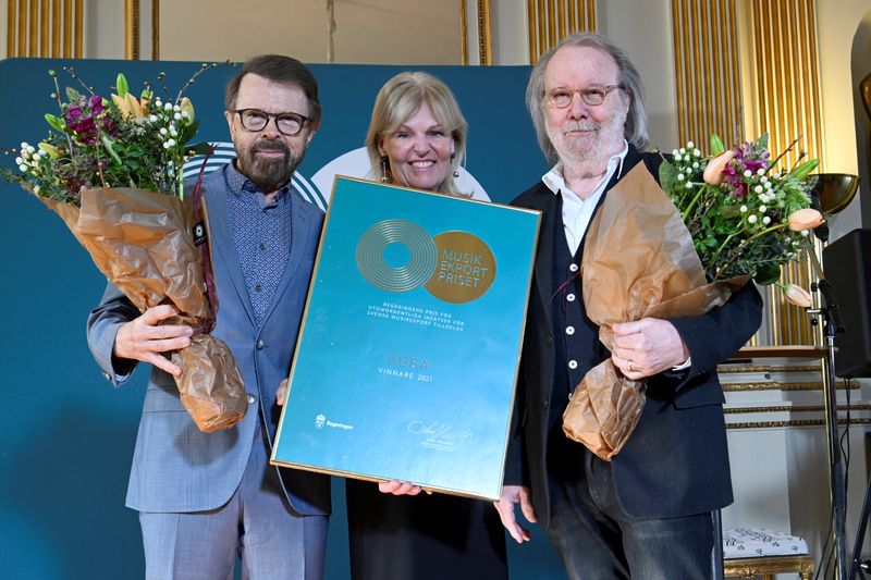 Bjorn Ulvaeus and Benny Andersson, representing ABBA, pose after receiving