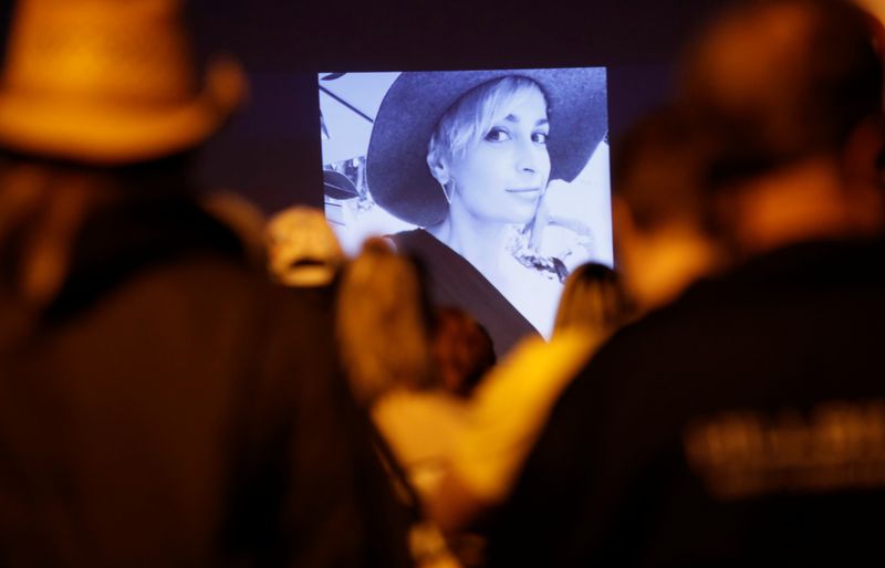 People attend a vigil for cinematographer Halyna Hutchins, who was