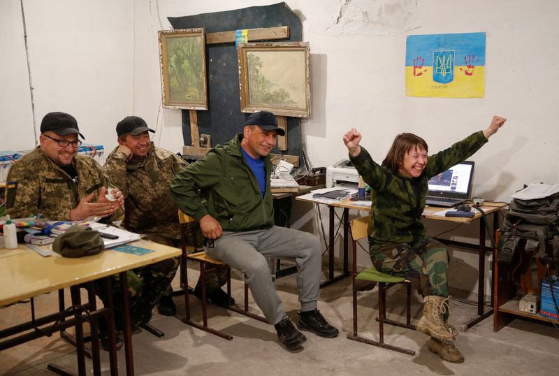 Ukrainian service members watch 2022 Eurovision Song Contest at a
