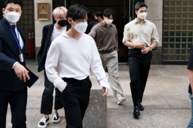 FILE PHOTO: Members of the South Korean band BTS exit