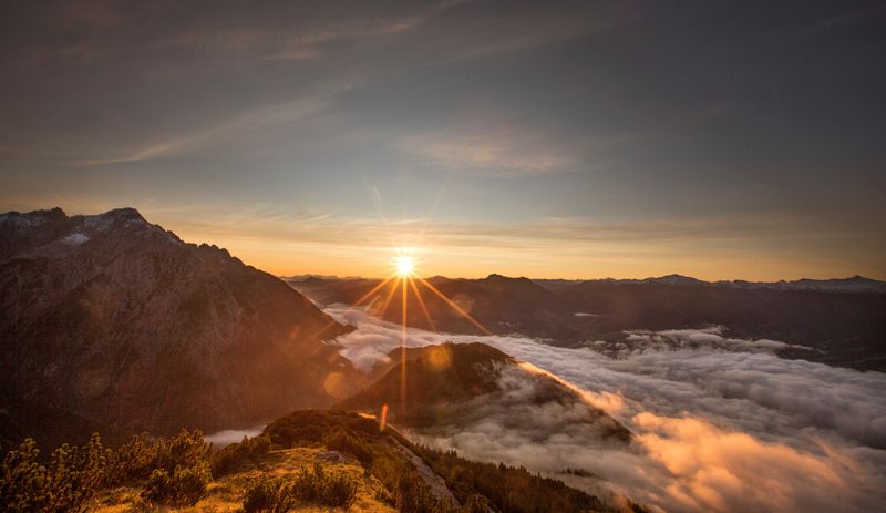 FILE PHOTO: The sun rises over mountain summits in the