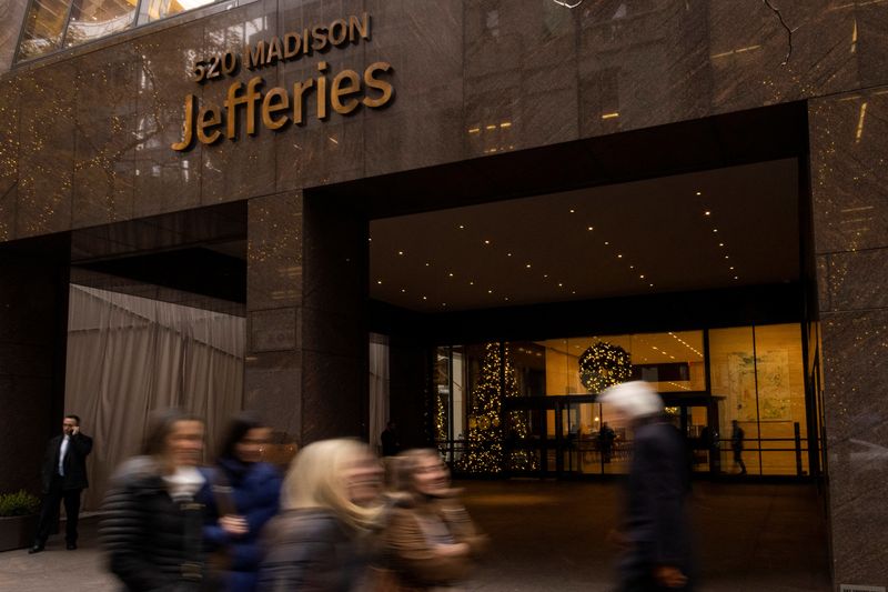 People walk outside of Jefferies Financial Group offices in Manhattan,