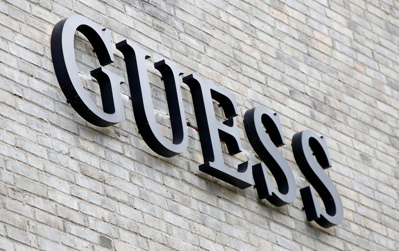 The logo of Guess is seen on an outlet store