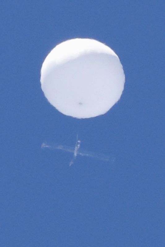 A balloon-like white object in the sky is pictured in