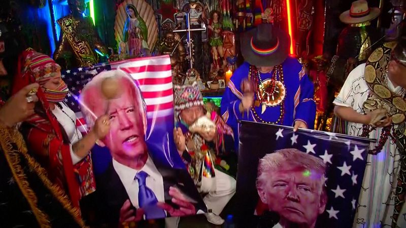 Peruvian shamans hold photos of Democratic presidential candidate Joe Biden