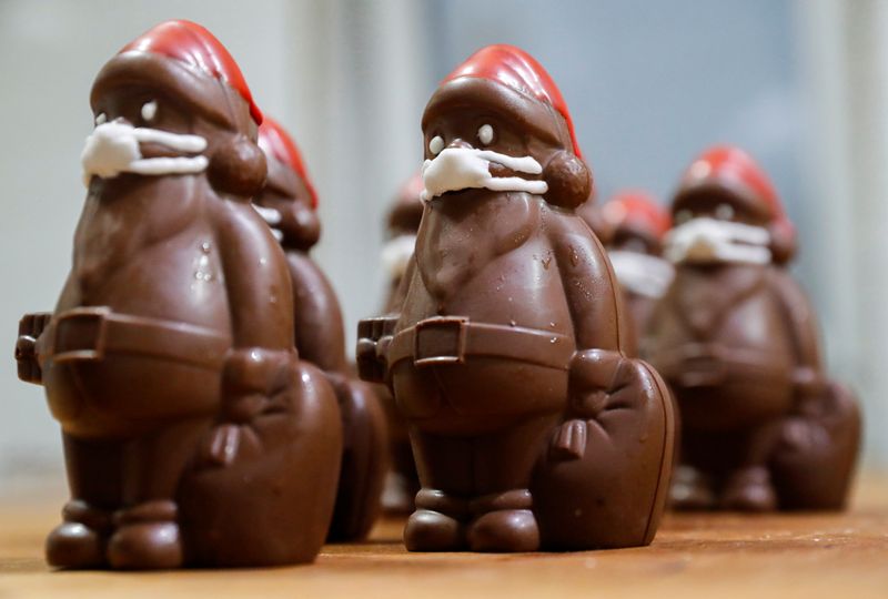 Chocolate Santas wearing protective face masks are seen in the