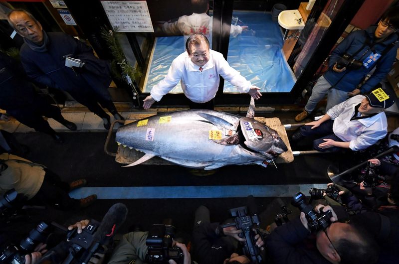 Kiyoshi Kimura, president of Kiyomura Corp., poses with a bluefin
