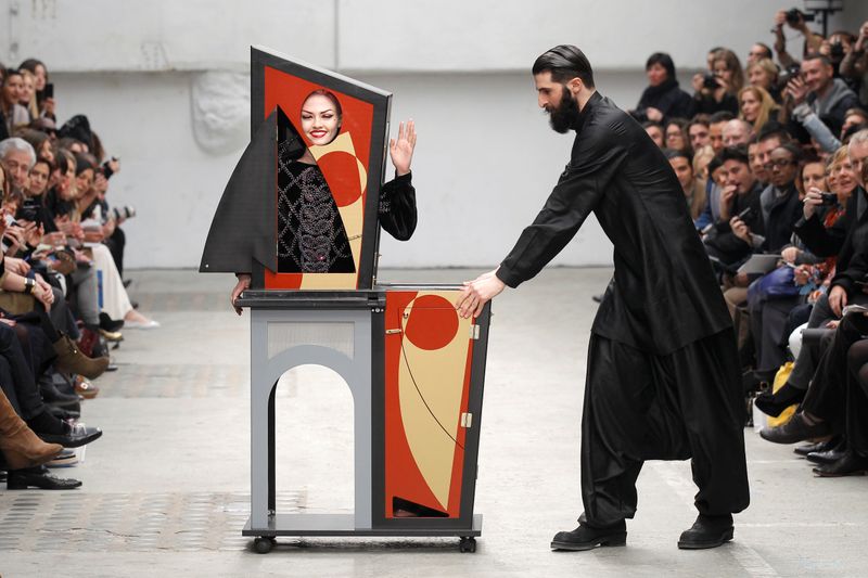 FILE PHOTO: A magician performs with a model who presents