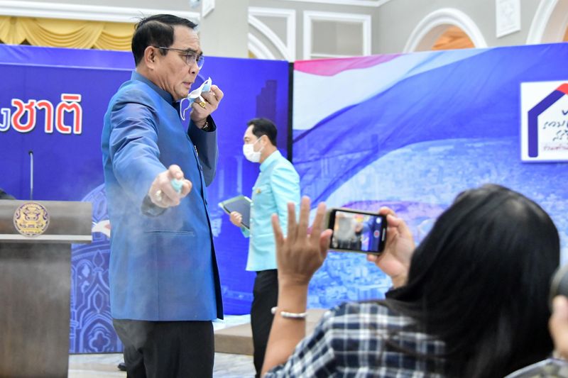 Thai Prime Minister Prayuth Chan-ocha sprays hand sanitizer at front