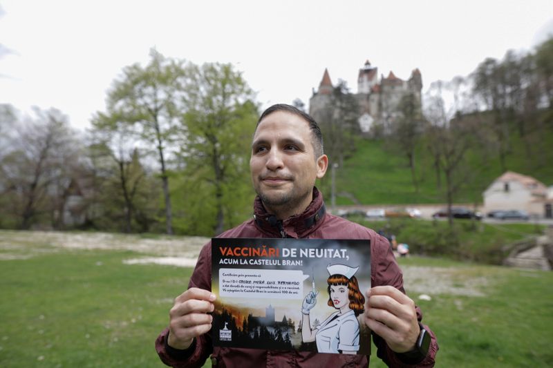 Fernando Orozco poses with a mock diploma attesting his vaccination