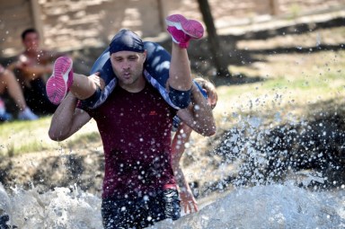 Participants compete in a wife-carrying championship