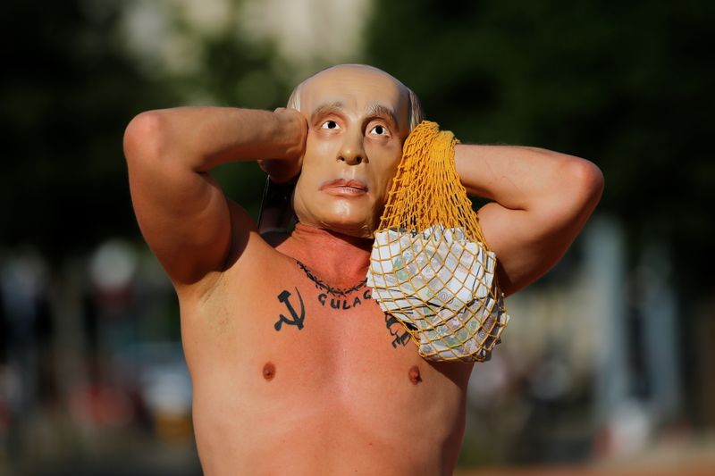 A protester wearing a mask of Russian President Vladimir Putin