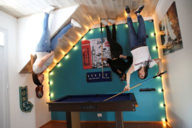People pose for a photo inside the upside down house,