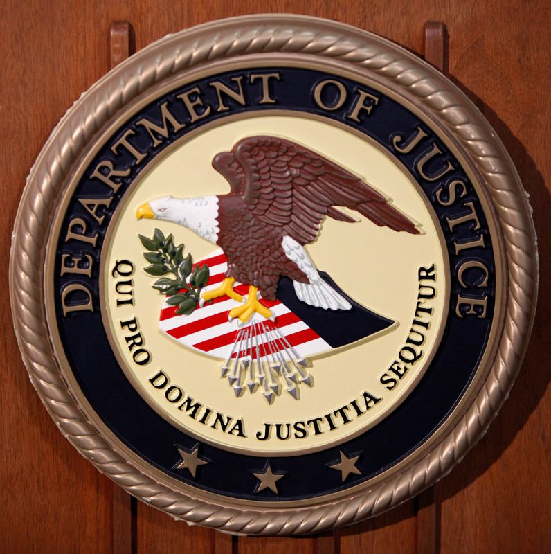 The Department of Justice logo is seen on the podium