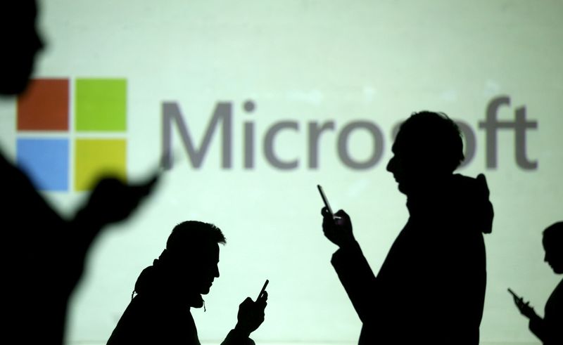 FILE PHOTO: Silhouettes of mobile users are seen next to